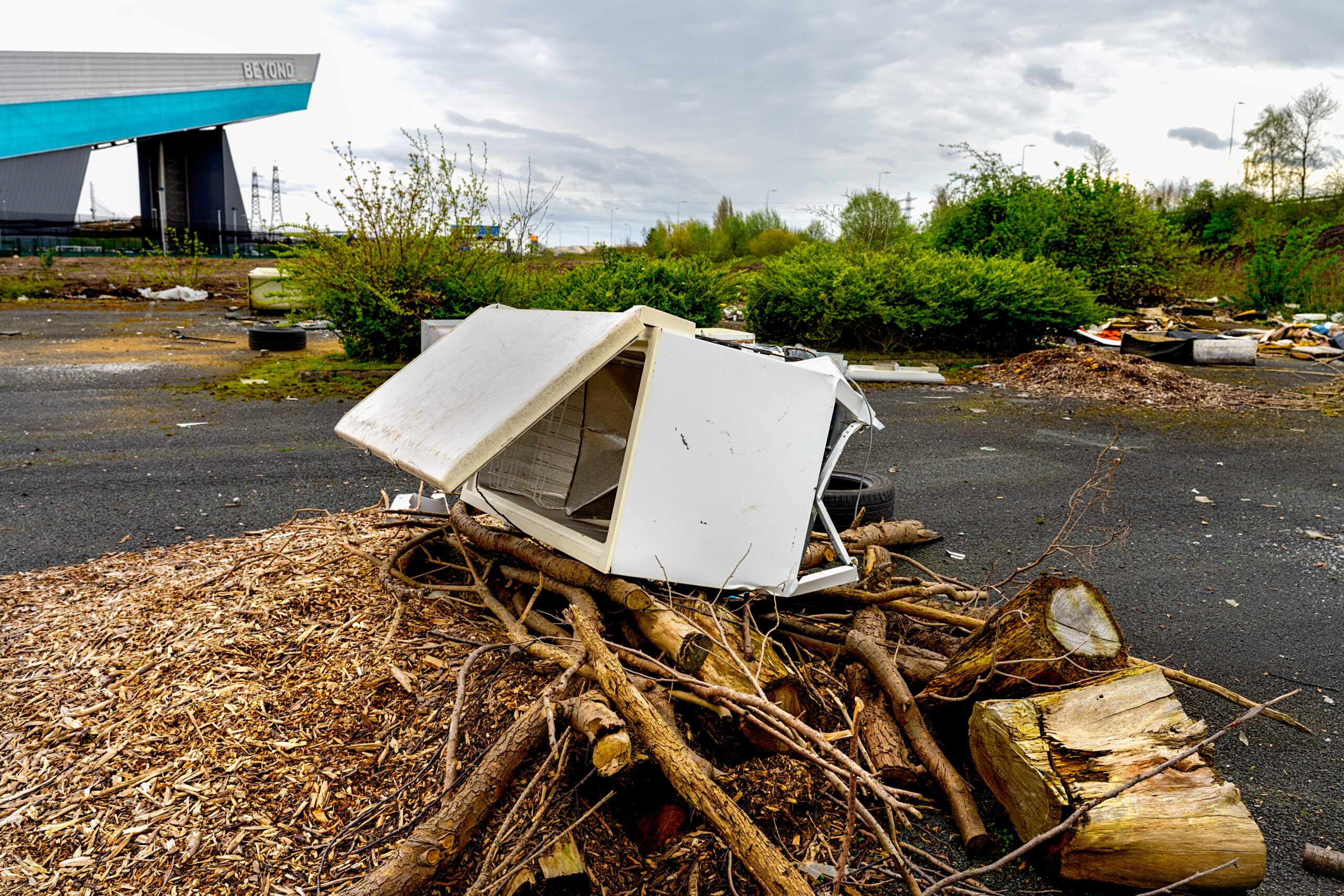 Fly tipping, rubbish dumped illegally by the road side. refrigerator freezer and garden waste
